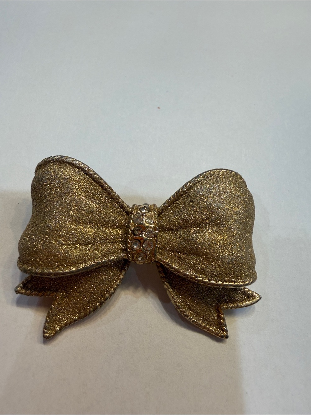Gold Glitter Bow Pin with Rhinestone Center